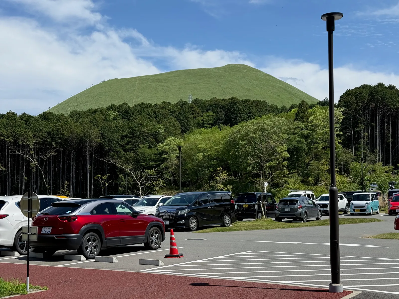 Mt. Omuro seen from the resort's parking lot — green, smooth, like an upturned bowl