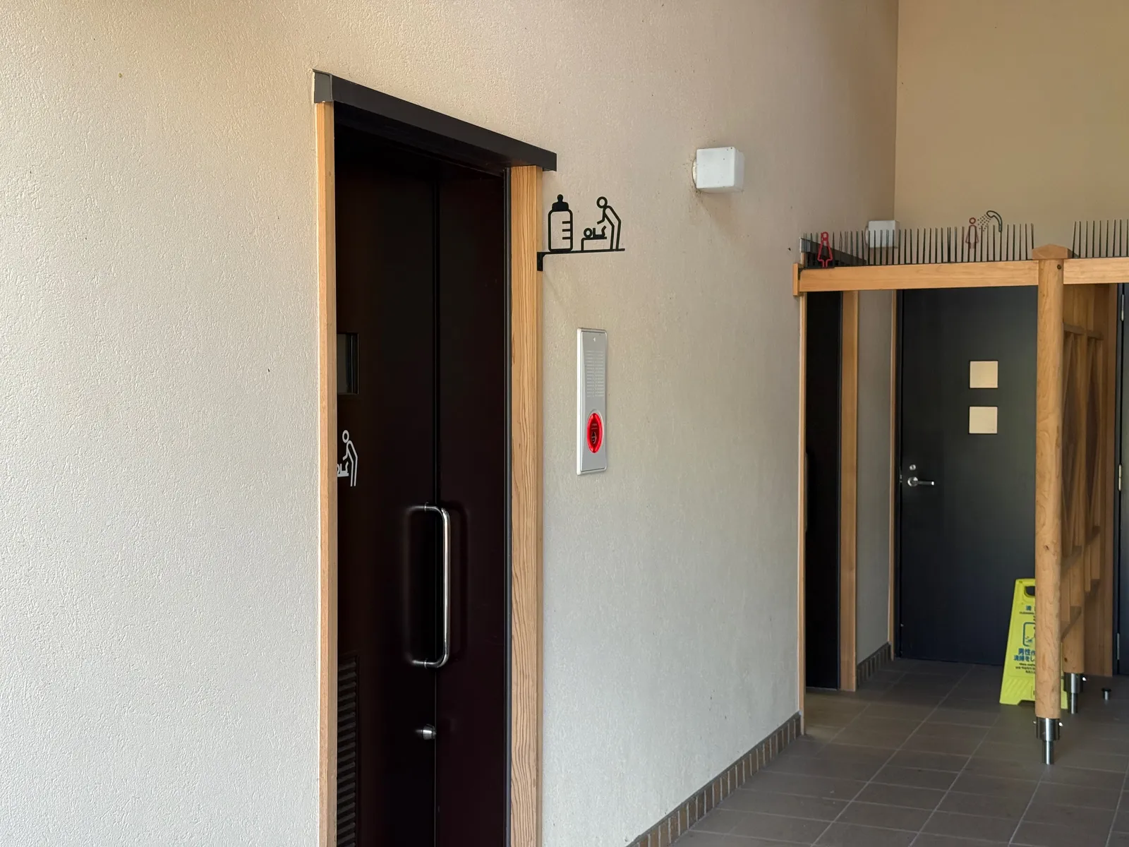 Restroom entrance. Signs on the wall mark the nursing room and diaper-changing area