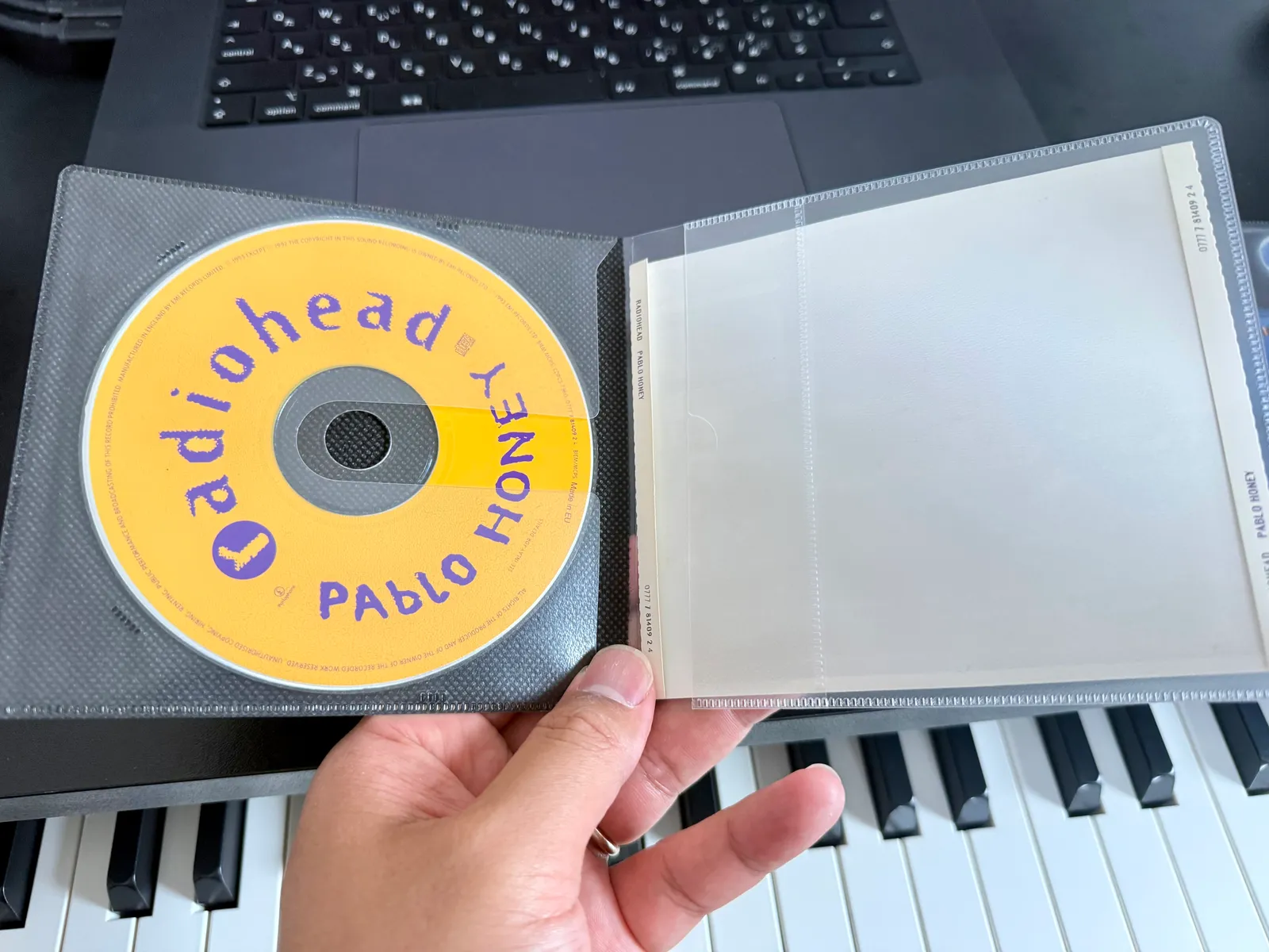 The other side of the same slim case — the disc on the left, the booklet pocket on the right