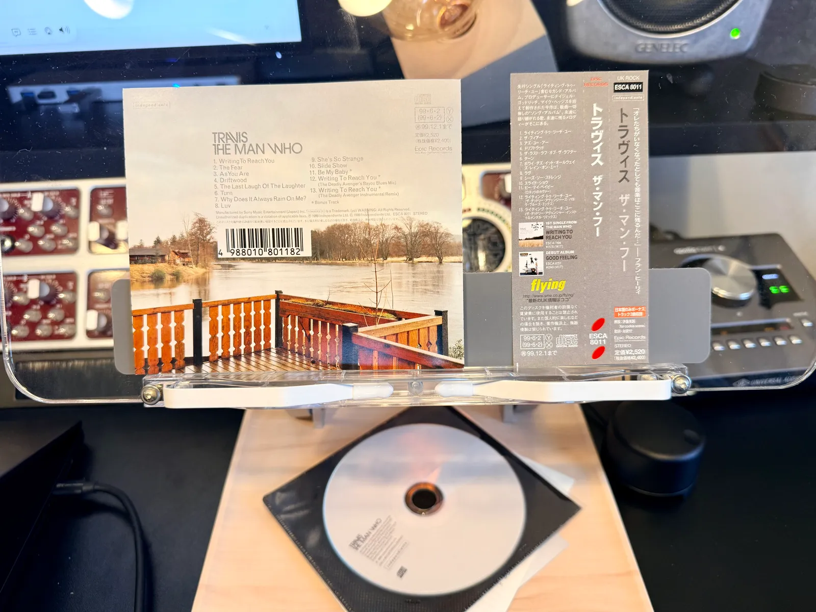 The back cover, the obi strip in orange ("flying"), and the disc resting on the table
